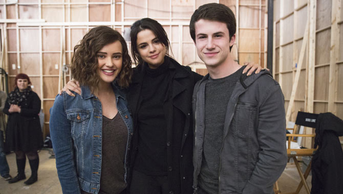 Katherine Langford and Dylan Minnette with Selena Gomez on-set