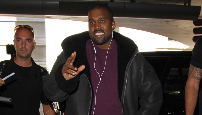 Kanye smiling at LAX