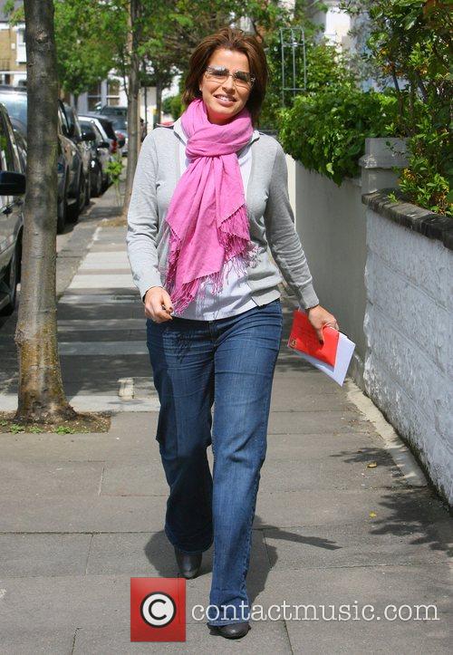 Natasha Kaplinsky wearing a bright pink scarf visits