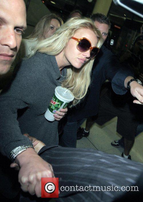 Britney Spears is surrounded by paparazzi as 
she arrives at LAX to catch a