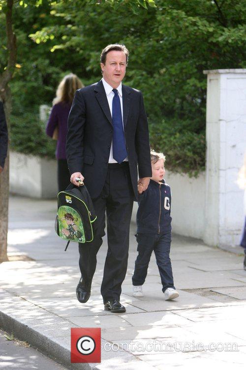 Prime Minister David Cameron walking his son Arthur