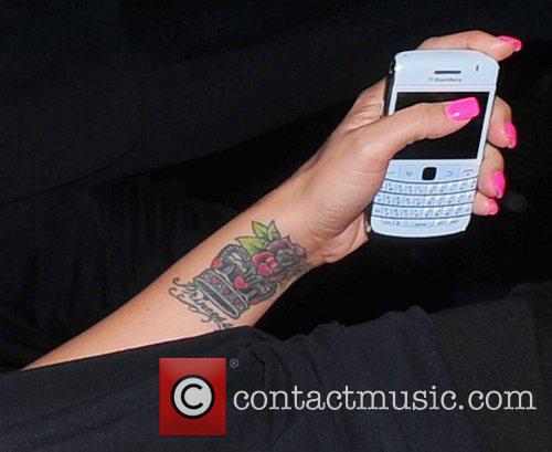 Katie Price showing off her new rose tattoo