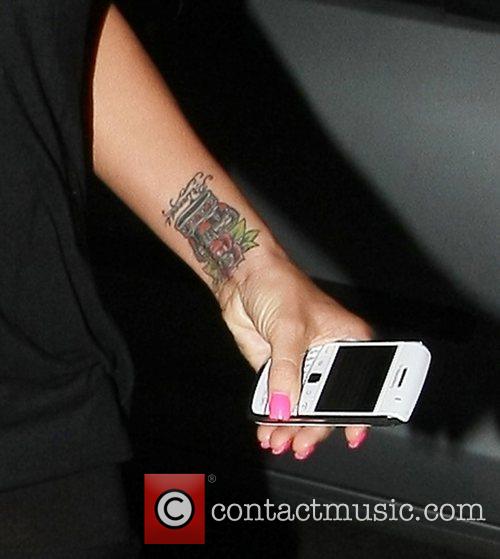 Katie Price showing off her new rose tattoo