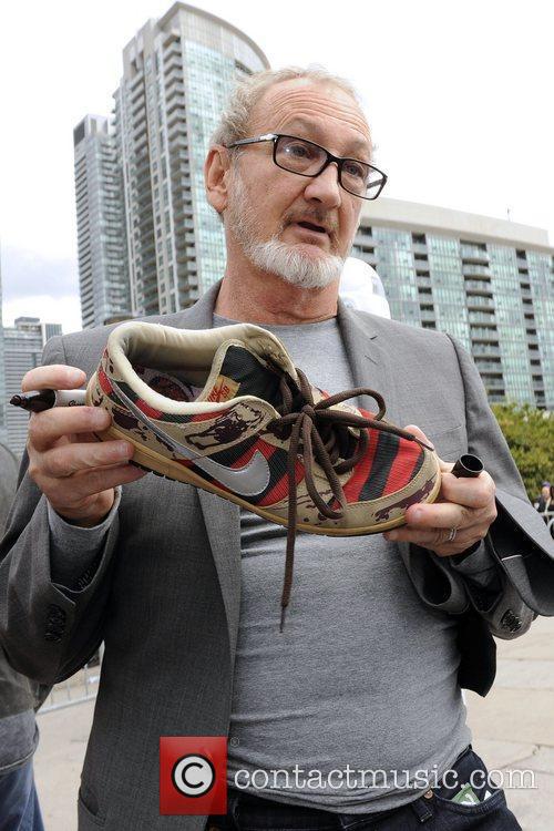Robert Englund signs a Nike'Freddy Krueger' shoe