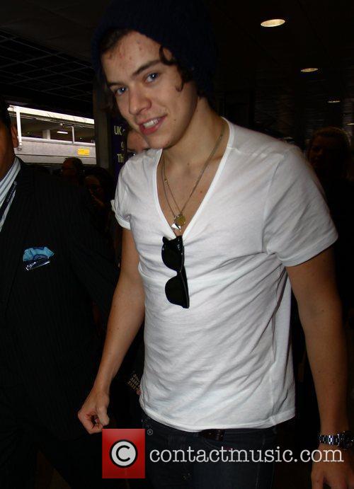 Harry Styles One Direction arrive at Heathrow airport