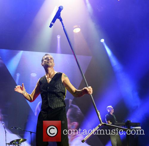 Dave Gahan performs a feat of strength with a mic stand at the O2, London