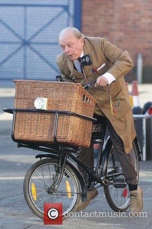 David Jason riding bicycle on 'Still Open All Hours' set