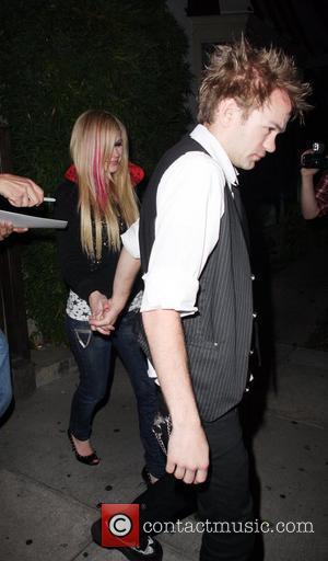 Avril Lavigne and husband Deryck Whibley leaving Koi where they dined for 