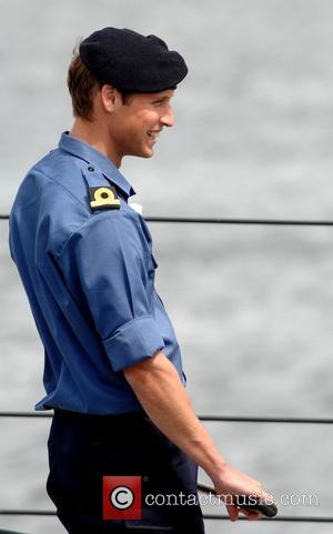prince william royal navy. Prince William smiles during