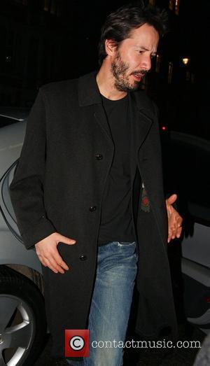 Keanu Reeves arriving at his hotel wearing old brown shoes picture