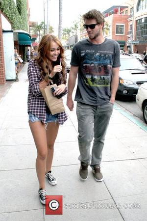 Miley Cyrus And Liam Hemsworth Miley Cyrus Sucking On A Lollipop While