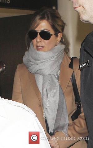 Jennifer Aniston arrives on a flight into LAX and is escorted out by 