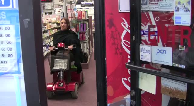 Amy Childs Plays On A Scooter Inside Drugstore