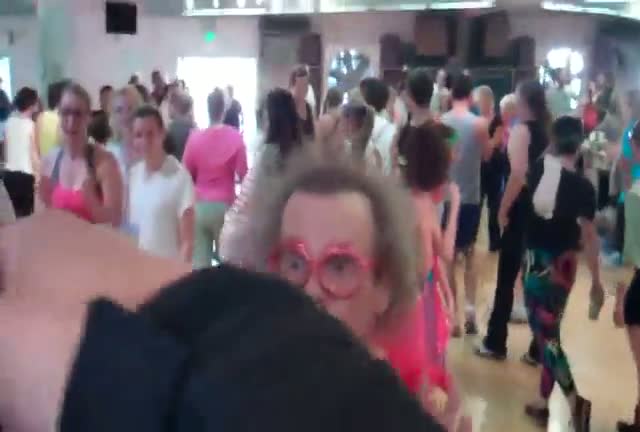 The flamboyant fitness guru Richard Simmons arrives at his aerobics dance studio dressed in a red feathered leotard and wearing some red glasses shaped as lips