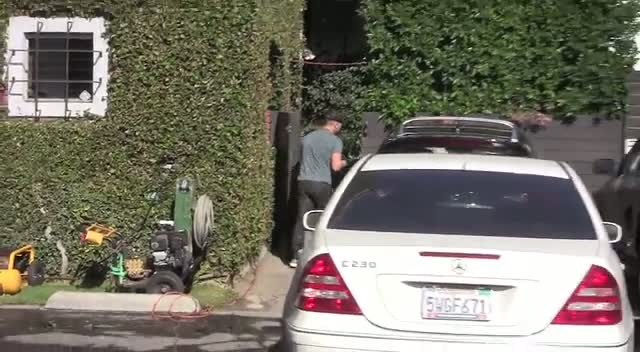 Emma Stone Hides From Photographers On Her Way To Her Car