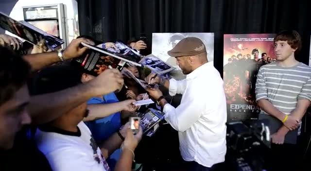 Randy Couture Autographs Fan Photos At Expendables 2 Premiere