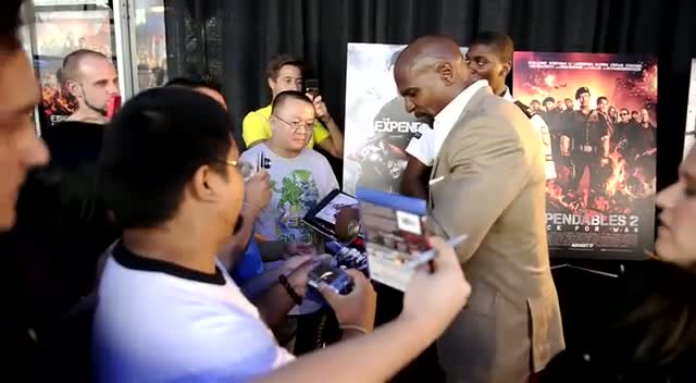 Terry Crews Smiles For The Camera While Signing Autographs At Expendables 2 Premiere