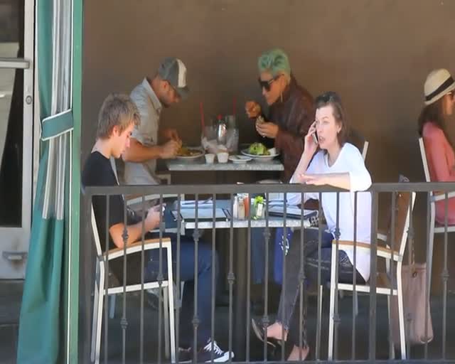 Casually Dressed Milla Jovovich Talks On Phone During Breakfast Date With Friend