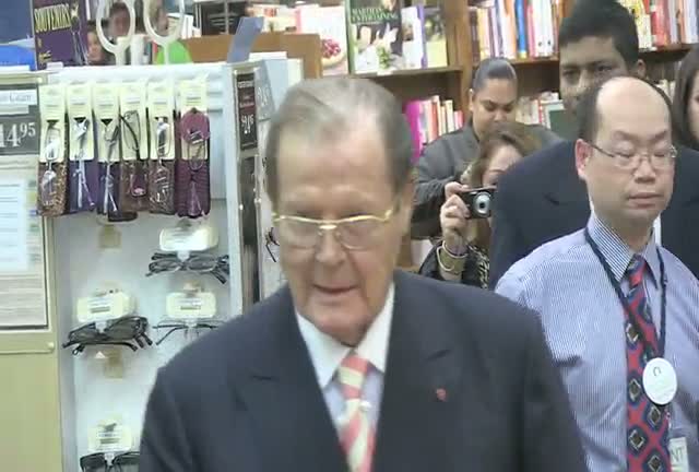 Sir Roger Moore Meets Young Bond Fan At 'Bond On Bond' Book Signing