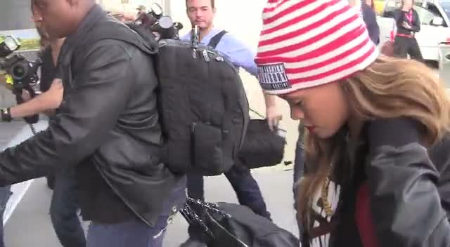 Rihanna Shields Eyes From Cameras In Paparazzi Crowd At LAX