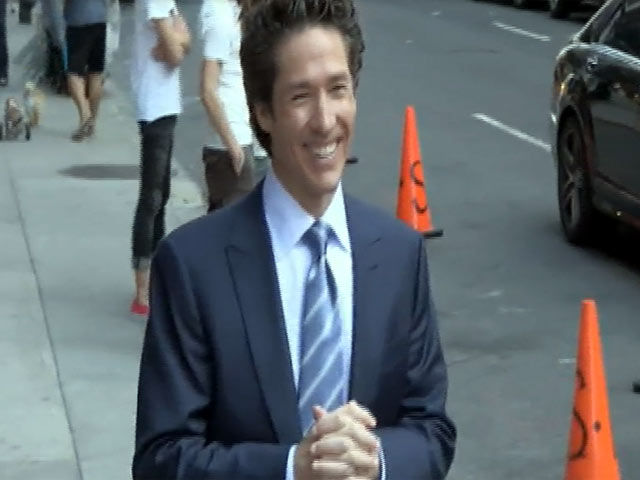 Joel Osteen Poses For Photos With Fans While Out In New York