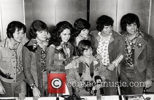 Shown (in center starting third from left): Marie Osmond, Jimmy Osmond (front), and Donny Osmond (rear) circa 1975
