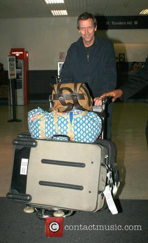 House M.D. star, Hugh Laurie arriving at LAX from London plenty of bags as he heads to getting back to...