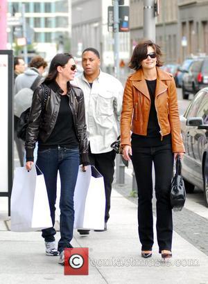 Katie Holmes with a friend and a bodyguard after shopping at The Corner at Gendarmenmarkt. She bought the brown leather...