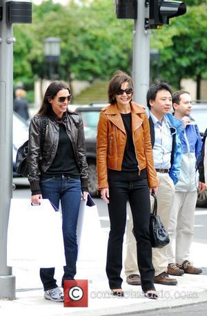 Katie Holmes with a friend after shopping at The Corner at Gendarmenmarkt. She bought the brown leather jacket she's wearing...