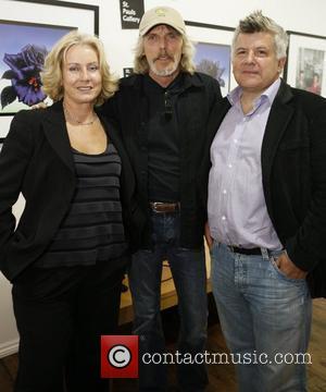 Scott Gorham (centre) of Thin Lizzy attends the launch of 195 limited edition signed prints of Black Rose album cover...