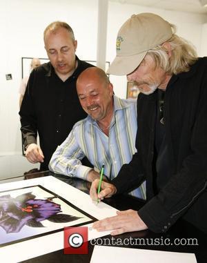 Scott Gorham of Thin Lizzy signs a limited edition print of the Black Rose album cover at St. Pauls Gallery...