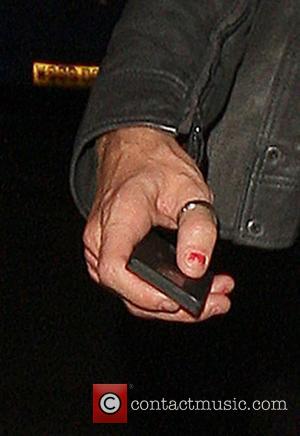 Rhys Ifans leaving the Bungalow 8 club wearing nail varnish which matches that of his companion London, England - 12.08.08
