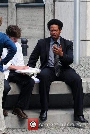 Gary Dourdan is looking at his iPhone at the set of the movie Fire in Charlottenburg Berlin, Germany - 30.08.08