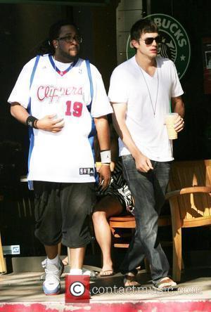 Ashton Kutcher  stops by Starbucks coffee in Beverly Glen Market with a friend to pick up a Frappuccino. Los...