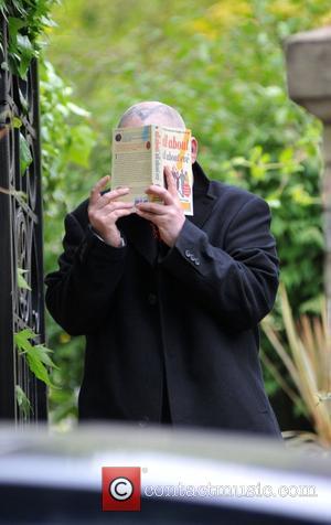 Boy George aka George O'Dowd leaves his home holding a copy of 'All About All About Eve' to cover his...