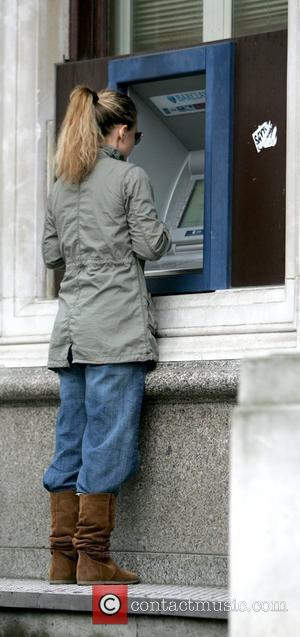 Geri Halliwell withdraws money while out and about with her daughter in London.  Lodnon, England - 17.04.09