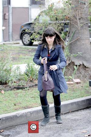 Zooey Deschanel with a splint on her middle finger, leaving M Cafe after eating lunch with a friend Los Angeles,...