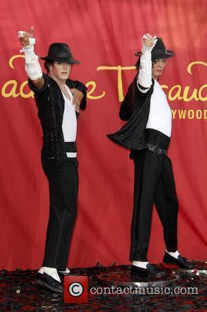 Michael Jackson impersonator Joby Rogers poses with a wax figure of Michael Jackson at Madame Tussauds in Hollywood, California, during...