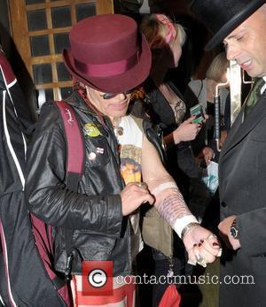 Adam Ant at the Ivy with new tattoos on his arm protected by cling film London, England - 01.09.10