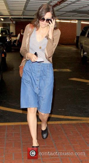 Maggie Gyllenhaal arriving at a medical centre while wearing a button-down denim skirt and black clogs Los Angeles, California -...