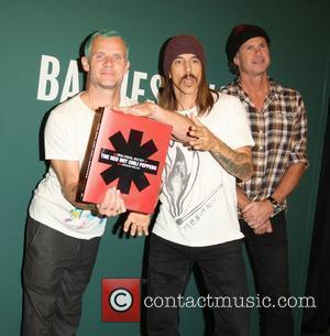 Flea aka Michael Peter Balzary, Anthony Kiedis and Chad Smith Red Hot Chili Peppers promote their new book 'The Red...