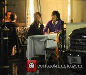 Ronnie Wood and his girlfriend Ana Araujo pop outside for a cigarette break, during a meal together at a restaurant...