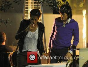 Ronnie Wood and his girlfriend Ana Araujo pop outside for a cigarette break, during a meal together at a restaurant...