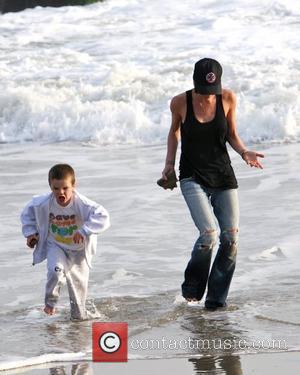 Victoria Beckham and Cruz Beckham playing on the beach and getting their feet wet in the water Malibu, USA -...