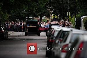 Amy Winehouse's body is seen being carrried...