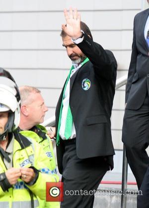 Eric Cantona gives a wave as he leaves the Lowry Hotel to watch the Manchester United vs New York Cosmos...