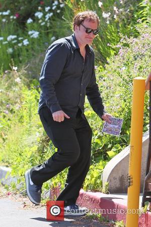 Quentin Tarantino goes to Cafe Med restaurant on Sunset Plaza. When leaving, Quentin is seen holding a brochure for a...