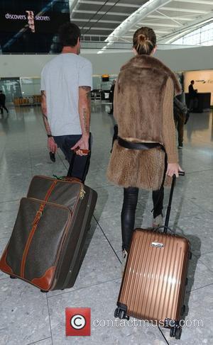 Rosie Huntington-Whiteley arriving at Heathrow Airport London, England - 21.09.11