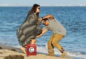 Selena Gomez playfully tussles with a friend as she celebrates her pal Ashley Tisdale's 27th birthday on the beach in...