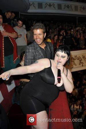 Beth Ditto of Gossip is watched by Perez Hilton as she performs live at the Shepherds Bush Empire London, England...